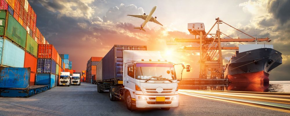 Container Truck In Ship Port For Business Logistics And Transpor Container truck in ship port for business Logistics and transportation of Container Cargo ship and Cargo plane with working crane bridge in shipyard at sunrise, logistic import export and transport industry background