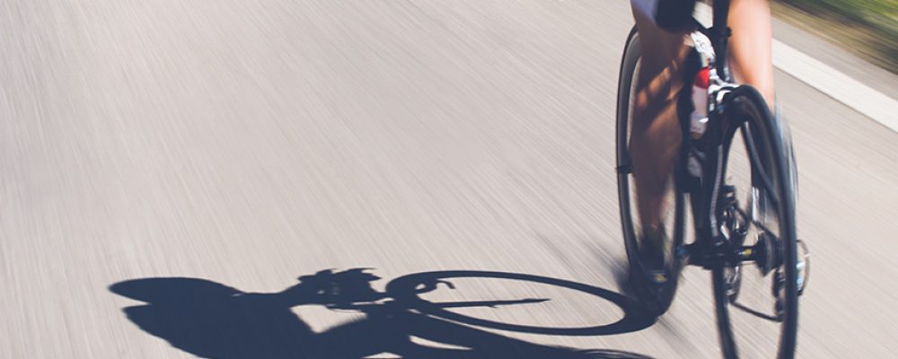 Speedy shadow – A cyclist at top speed on the triathlon race. Speedy shadow - A cyclist at top speed on the triathlon race.