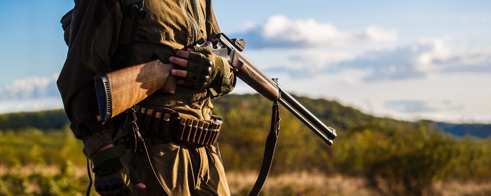 Hunter Man. Hunting Period, Autumn Season. Male With A Gun. Hunt Hunter man. Hunting period, autumn season. Male with a gun. Hunter with a backpack and a hunting gun. A hunter with a hunting gun and hunting form to hunt in an autumn forest. The man is on the hun